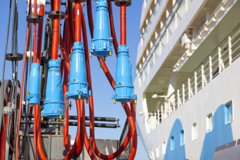 Carnival cruise ship sailing at sunset with a vibrant sky.